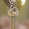 Close up of the gold paint splatters on the grey feather quill