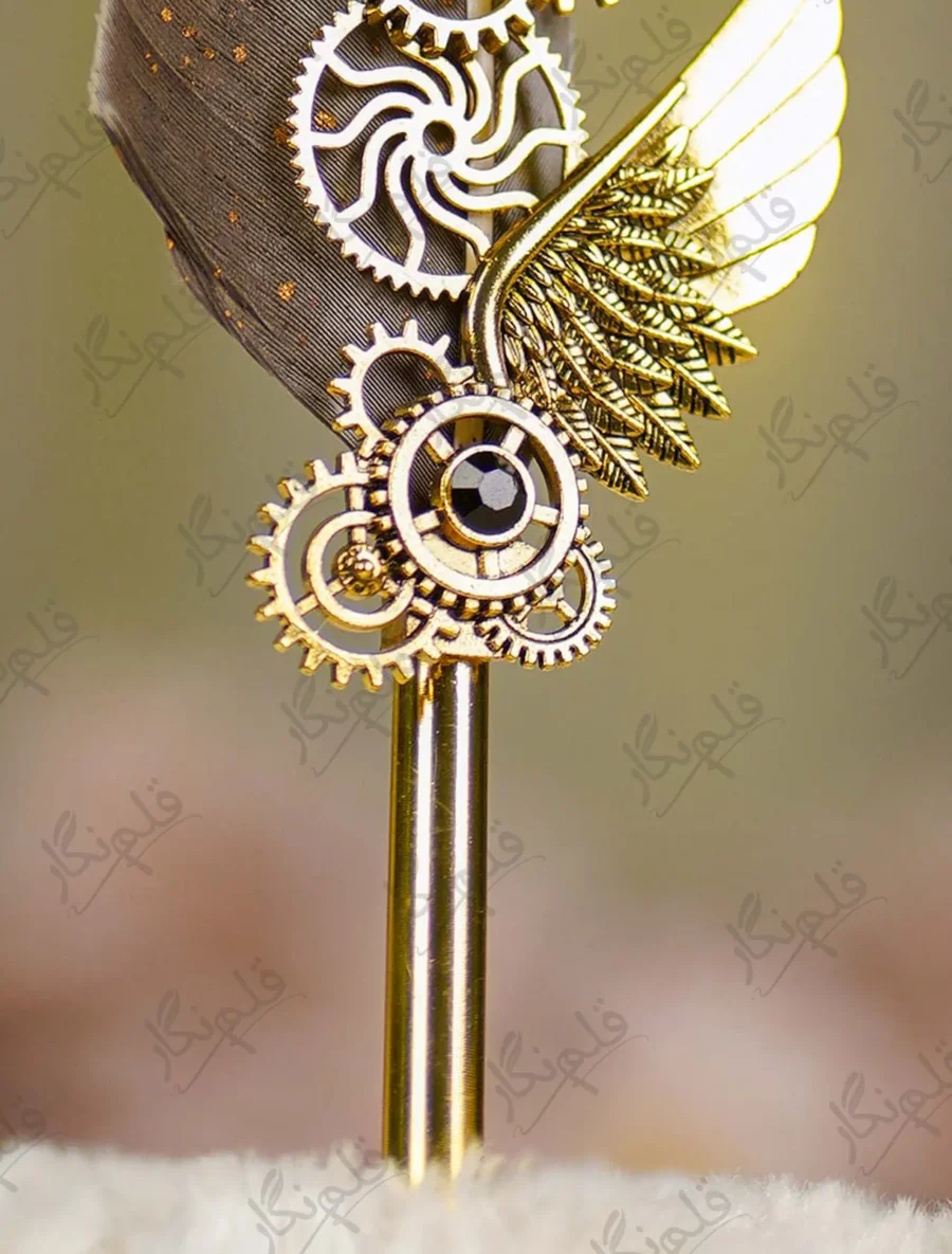Close up of the gold paint splatters on the grey feather quill