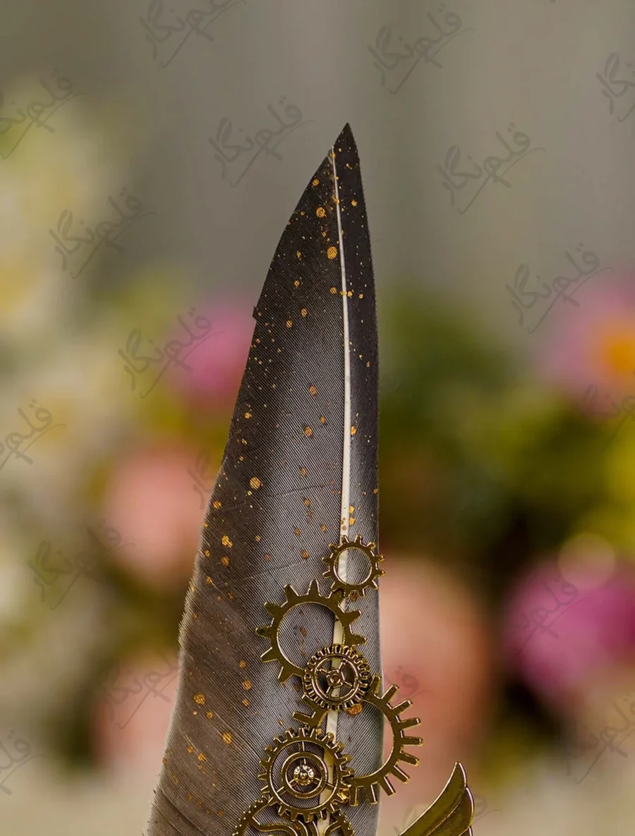 High angle close up of the grey feather and bronze gear cogs