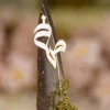 Elegant steampunk wedding signing pen lying on a soft white fur backdrop
