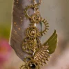 Close up of the brass gear cogwheels and winged design on the feather