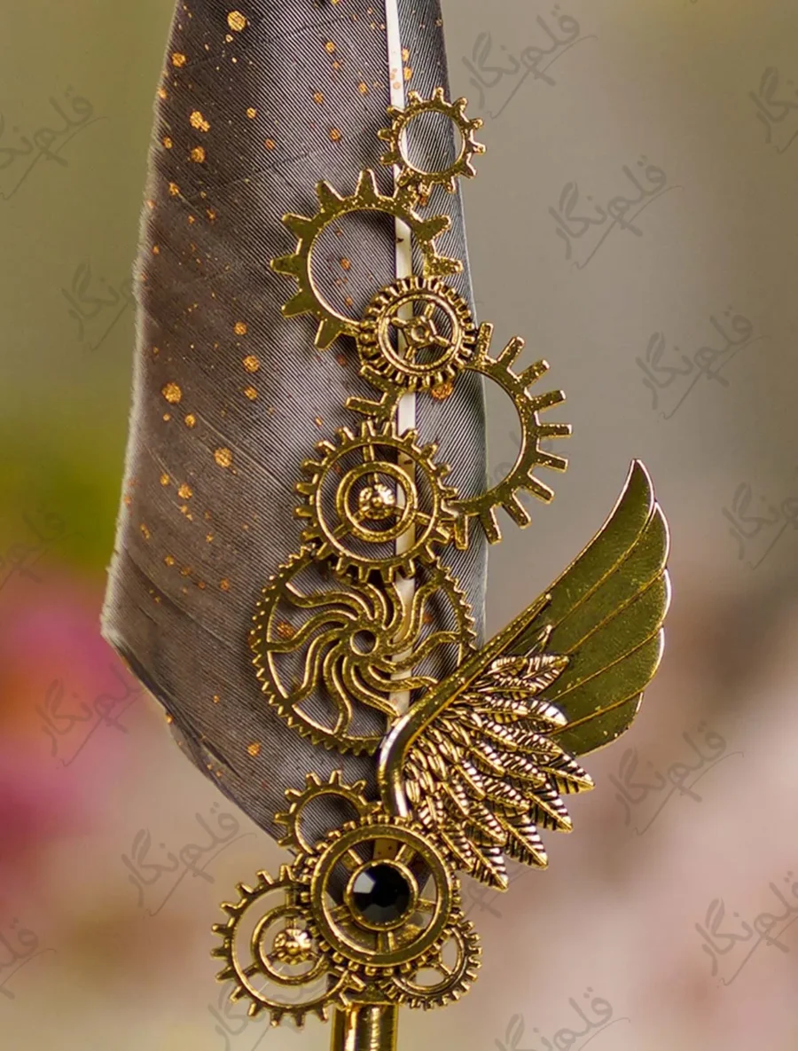 Close up of the brass gear cogwheels and winged design on the feather