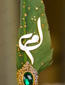 Gold-splattered green quill feather showing the metallic glitter paint
