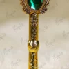 Gold mirror calligraphy name cutout against the gold-splattered green feather