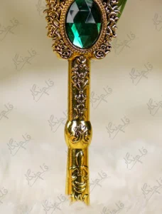 Gold mirror calligraphy name cutout against the gold-splattered green feather