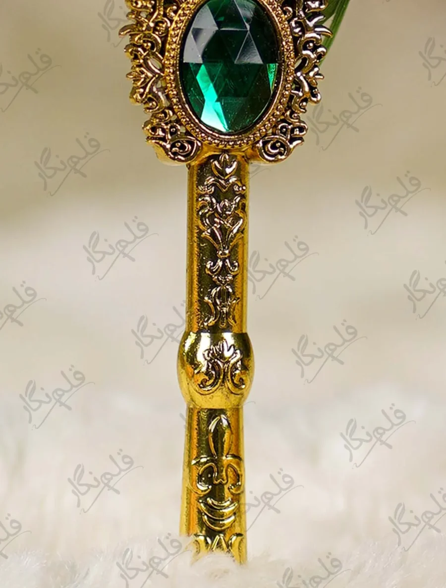 Gold mirror calligraphy name cutout against the gold-splattered green feather