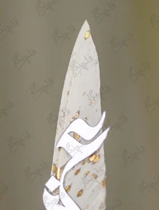 Close-up of the ornate gold handle and clear faceted crystal gemstone