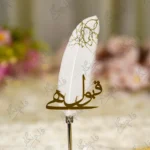 Silver chrome Nikkah pen with white feather decorated with gold glitter patterns and Qabool Hai script
