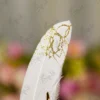 Close up of the golden mirror acrylic Qabool Hai script on the white feather signing pen