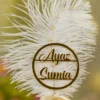 Customized version showing circular gold acrylic couple name circle on the feather