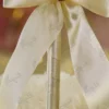 Alternate close up of the cream ribbon bow and pearl-and-rhinestone flower centerpiece