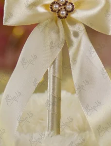 Alternate close up of the cream ribbon bow and pearl-and-rhinestone flower centerpiece