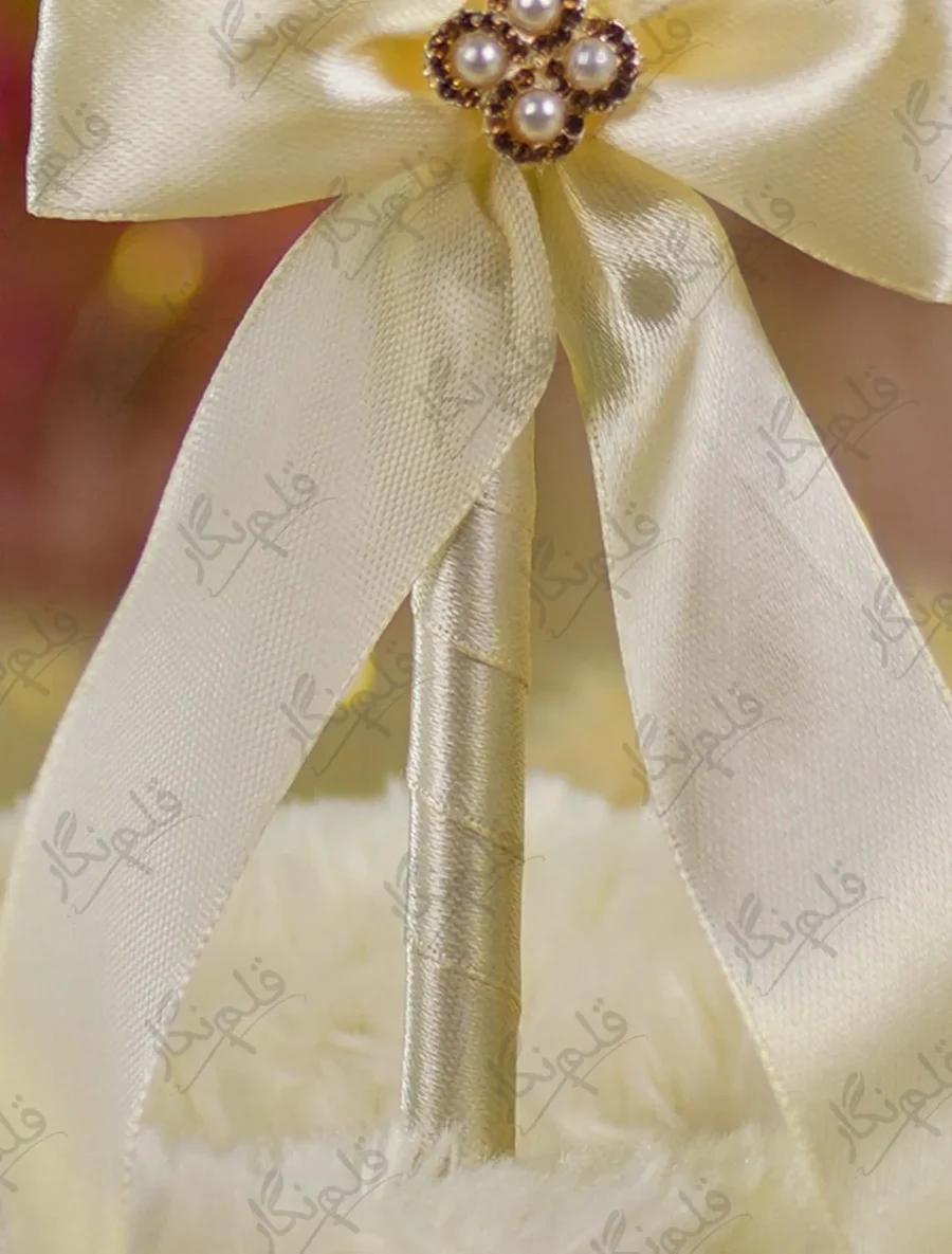 Alternate close up of the cream ribbon bow and pearl-and-rhinestone flower centerpiece