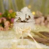 Elegant white feather Nikkah pen with gold Qabool Hai calligraphy against floral backdrop