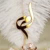 White feather showing detailed gold acrylic calligraphy close up