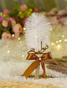 Side angle of the bronze ribbon bow with pearl and rhinestone button centerpiece