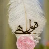 Side angle of the pink rose and white feather on the wedding signing pen