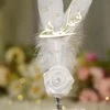 Detailed view of the scattered white pearl beads on the feather surface