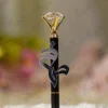 Detailed shot of the clear crystal diamond gem top on gold prongs