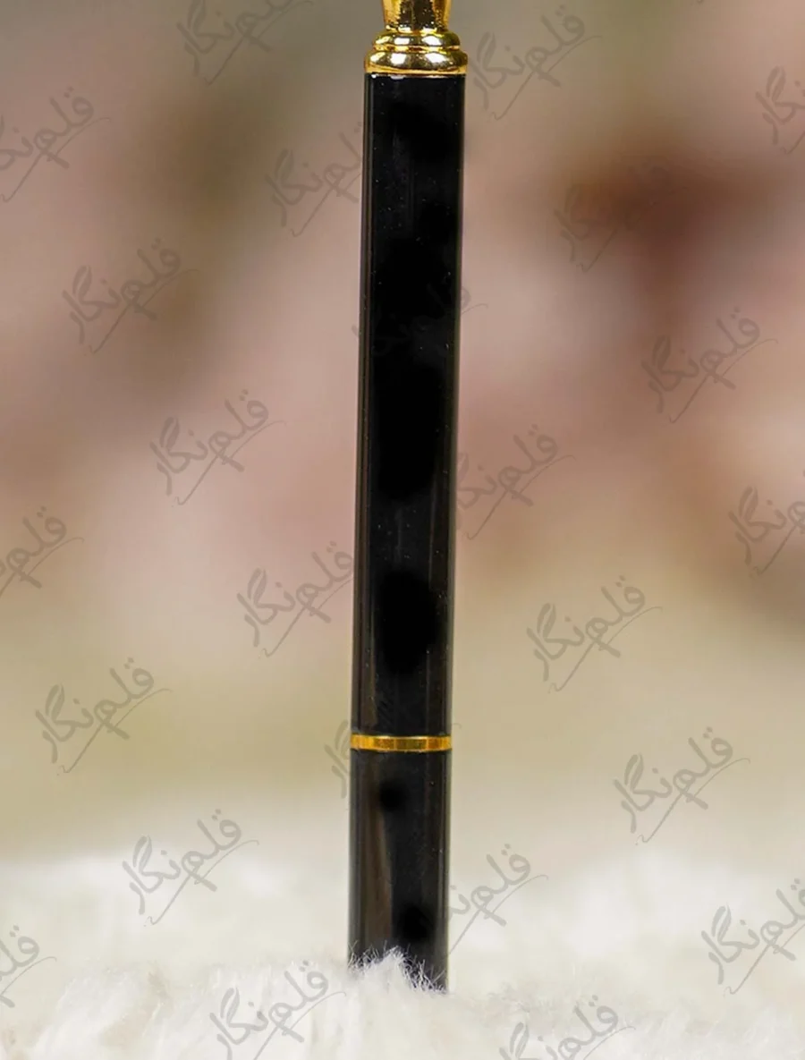High angle close up of the multi faceted crystal glass diamond top on black pen