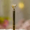 Gold metal Nikkah pen topped with a large clear crystal diamond gem and gold nameplate