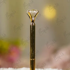 Gold metal Nikkah pen topped with a large clear crystal diamond gem and gold nameplate
