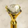 High angle close up of the multi faceted crystal glass diamond top on gold pen