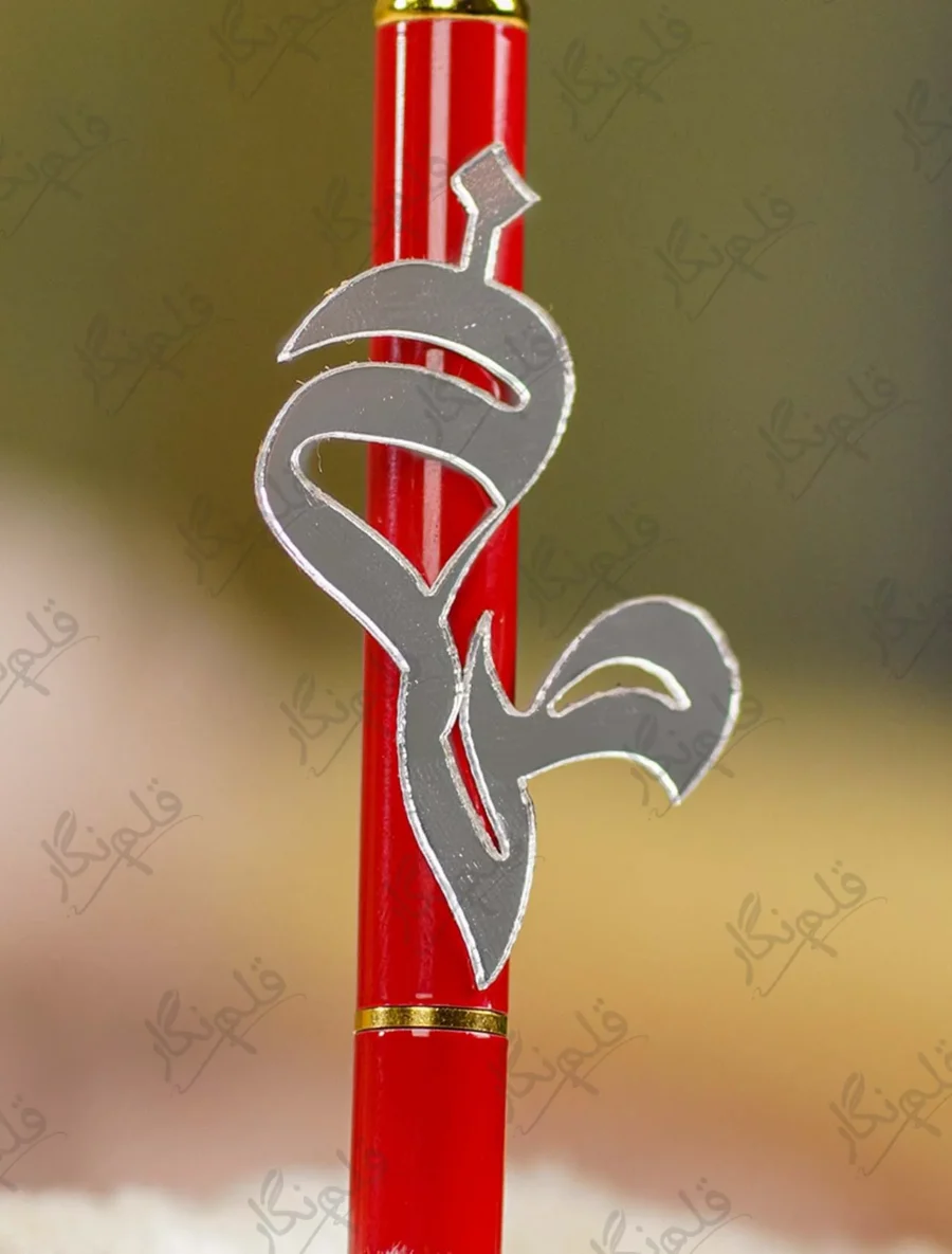 Close up of the red metal pen barrel with gold joint accents