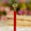Glossy red Nikkah pen topped with a clear crystal diamond and gold settings