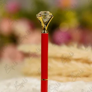 Glossy red Nikkah pen topped with a clear crystal diamond and gold settings
