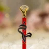 High angle close up of the multi faceted crystal glass diamond top on red pen