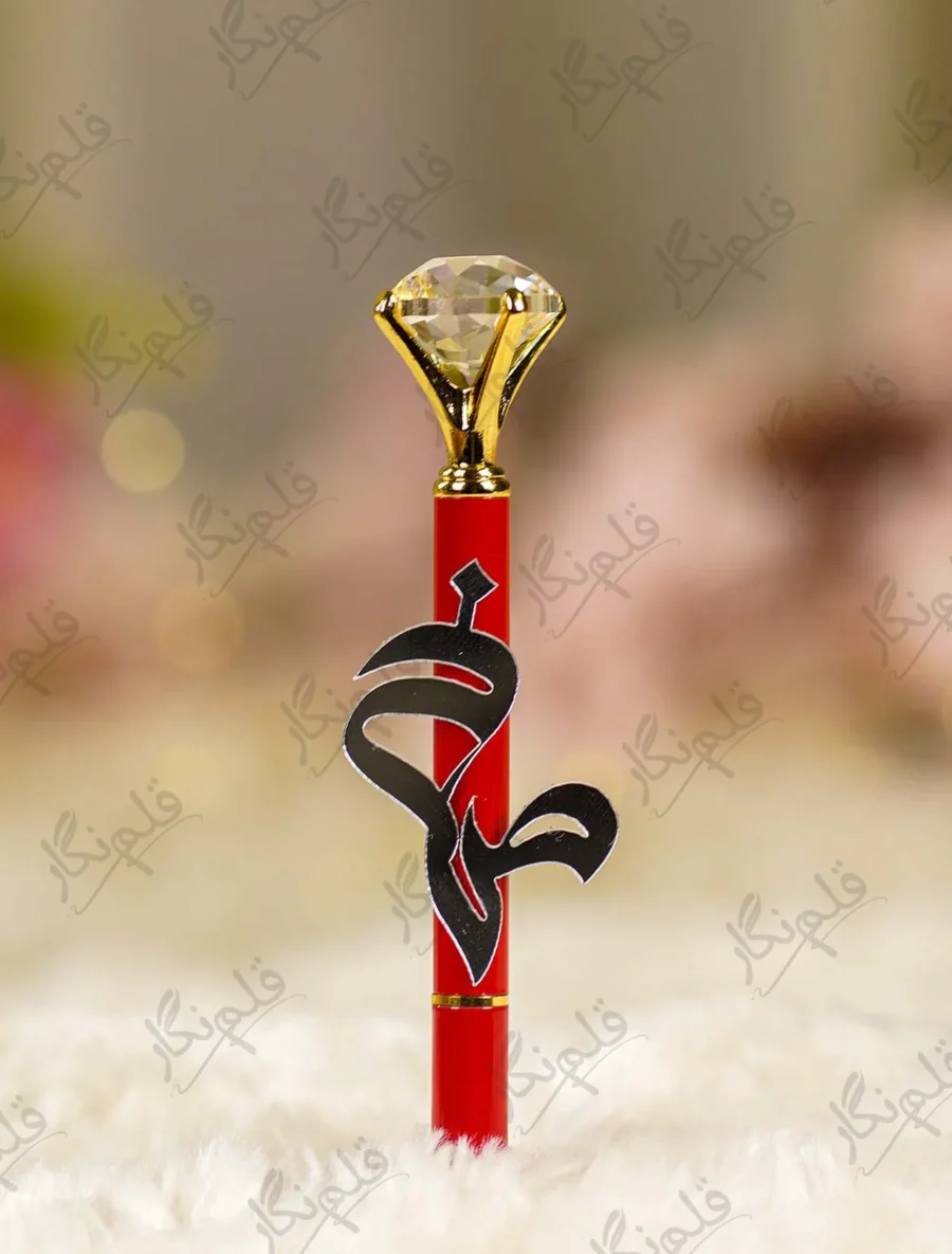 High angle close up of the multi faceted crystal glass diamond top on red pen