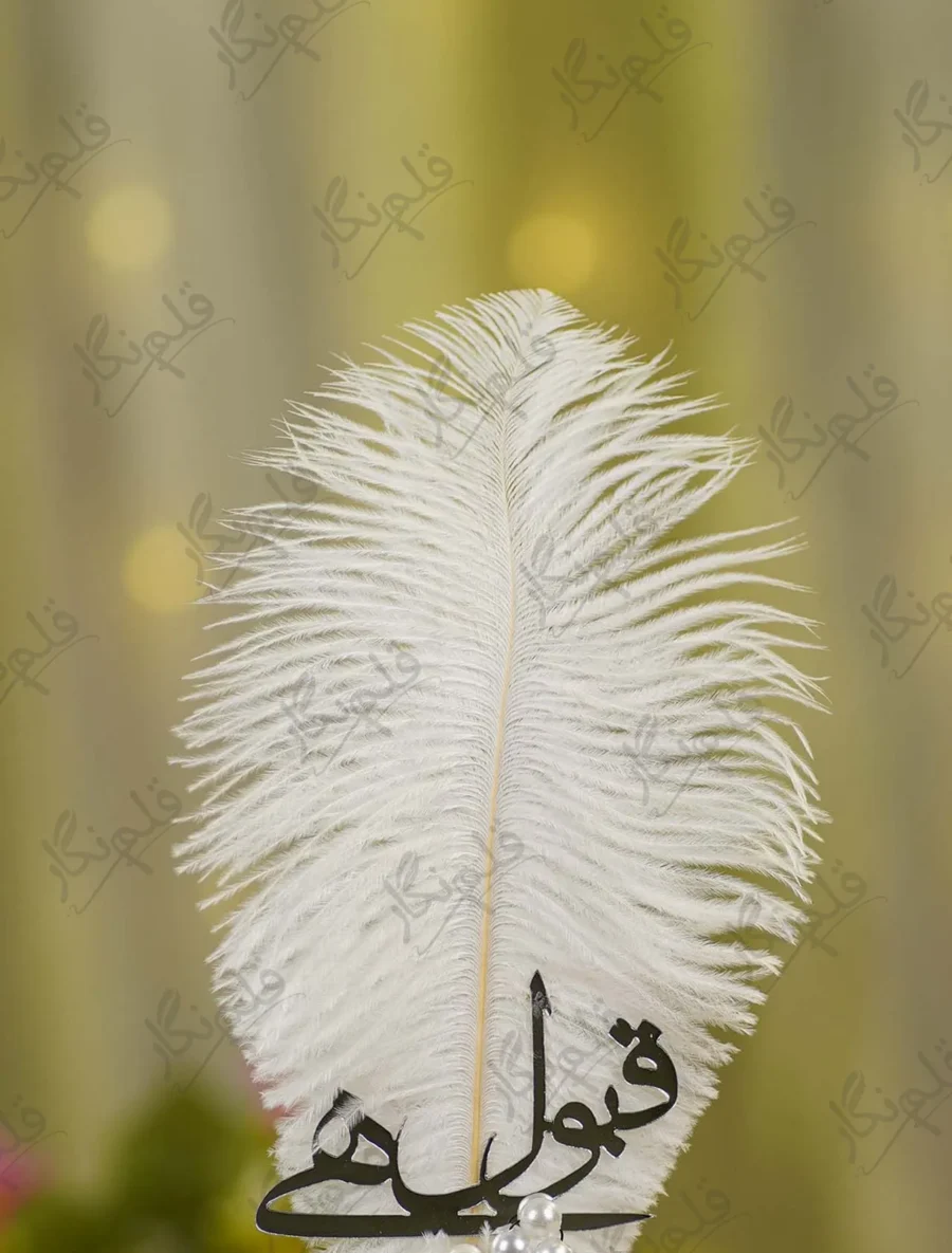 Close up of the black mirror acrylic Qabool Hai script on the white feather