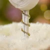 Detailed shot of the white satin rolled rose and branching pearl sprigs