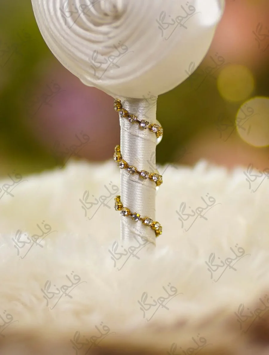 Detailed shot of the white satin rolled rose and branching pearl sprigs