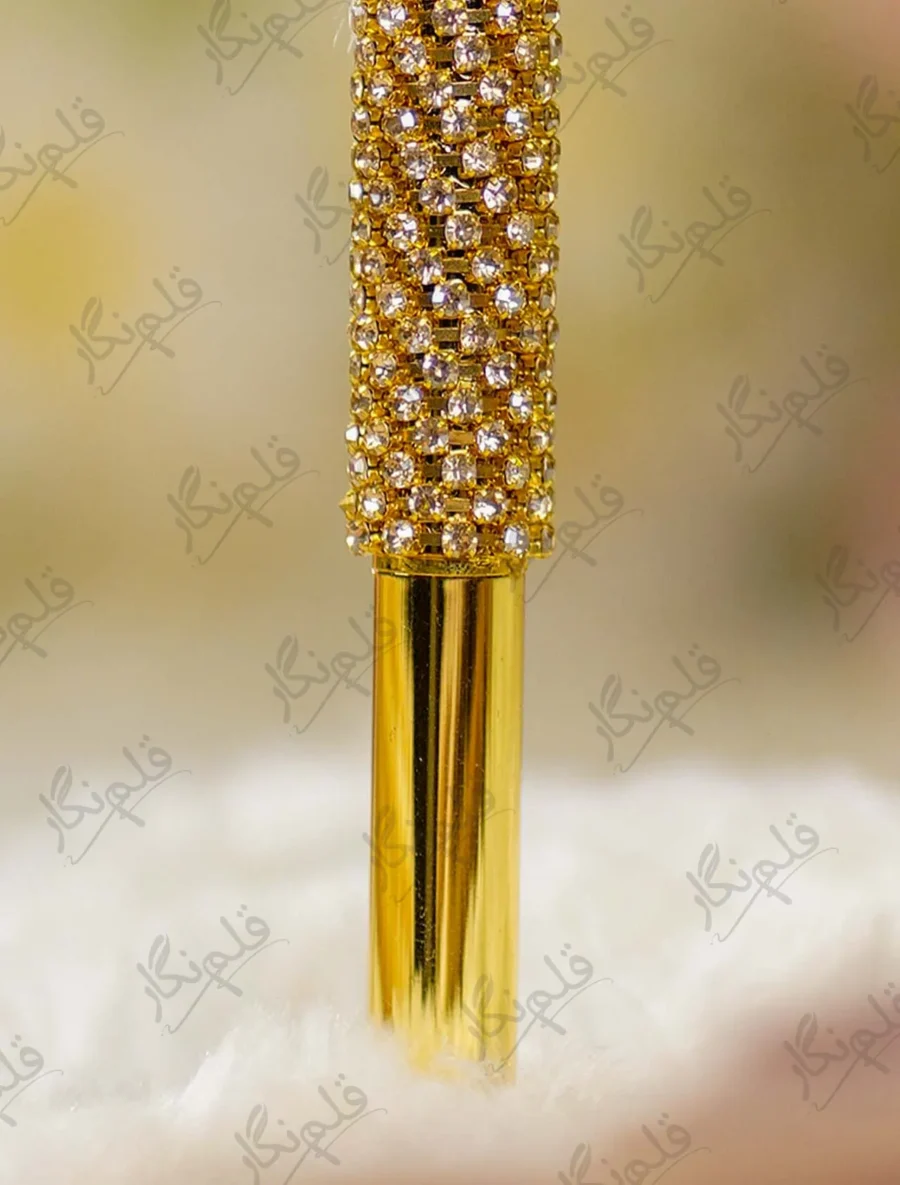 Close-up of the multi-faceted crystal diamond top set in gold prongs