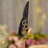 Black feather Nikkah pen with gold splatters and interlocking gold steampunk gears