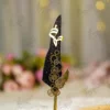 Close up of gold wing detail and gold splattered black feather quill
