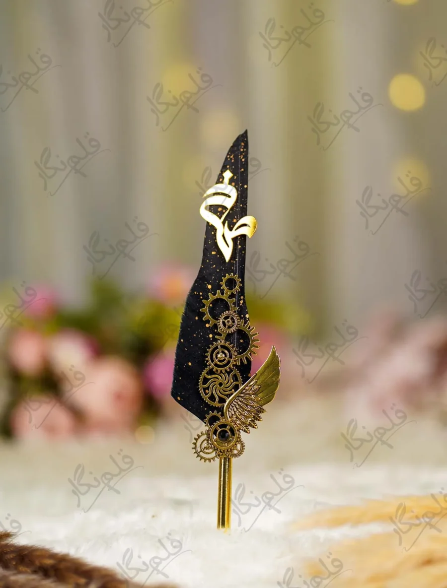 Close up of gold wing detail and gold splattered black feather quill