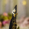 Elegant steampunk Nikkah signing pen displaying gold gears against a soft background