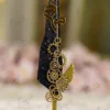 Black feather Nikkah pen featuring a gold mirror acrylic Bismillah calligraphy cutout at the top