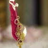 Side angle of the gold gears and wing assembly on red wedding pen