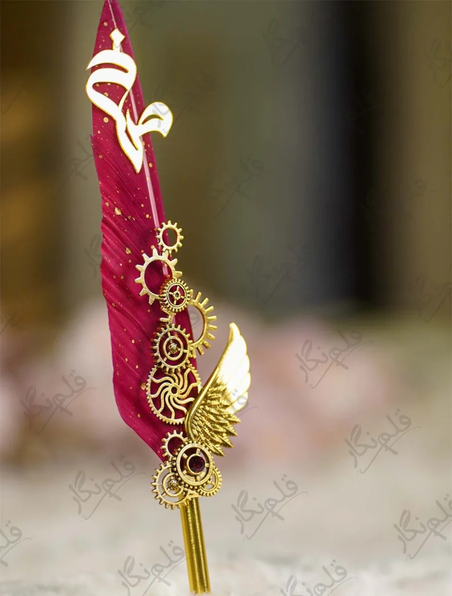 Side angle of the gold gears and wing assembly on red wedding pen