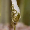 Detailed view of clear rhinestone set inside the gold gear of the Nikkah pen