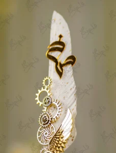 Side angle of the gold gears and wing assembly on white wedding pen
