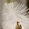 Close up showing custom Maha name cutout on the white feather