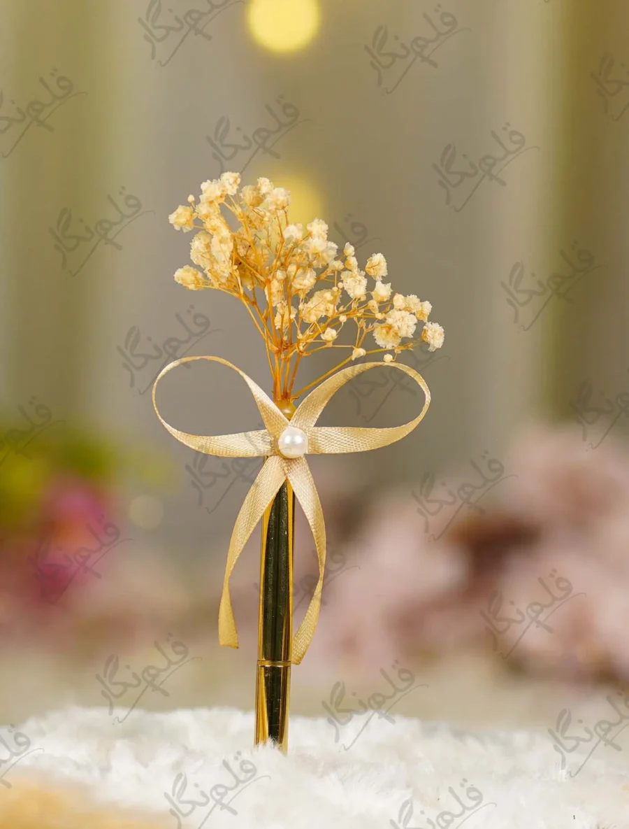 Close up of the champagne satin ribbon bow and central pearl bead accent