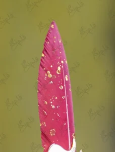 Close up of the red crystal gemstone set in a gold filigree oval frame