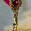 Close up of the red quill feather showing gold paint splatters
