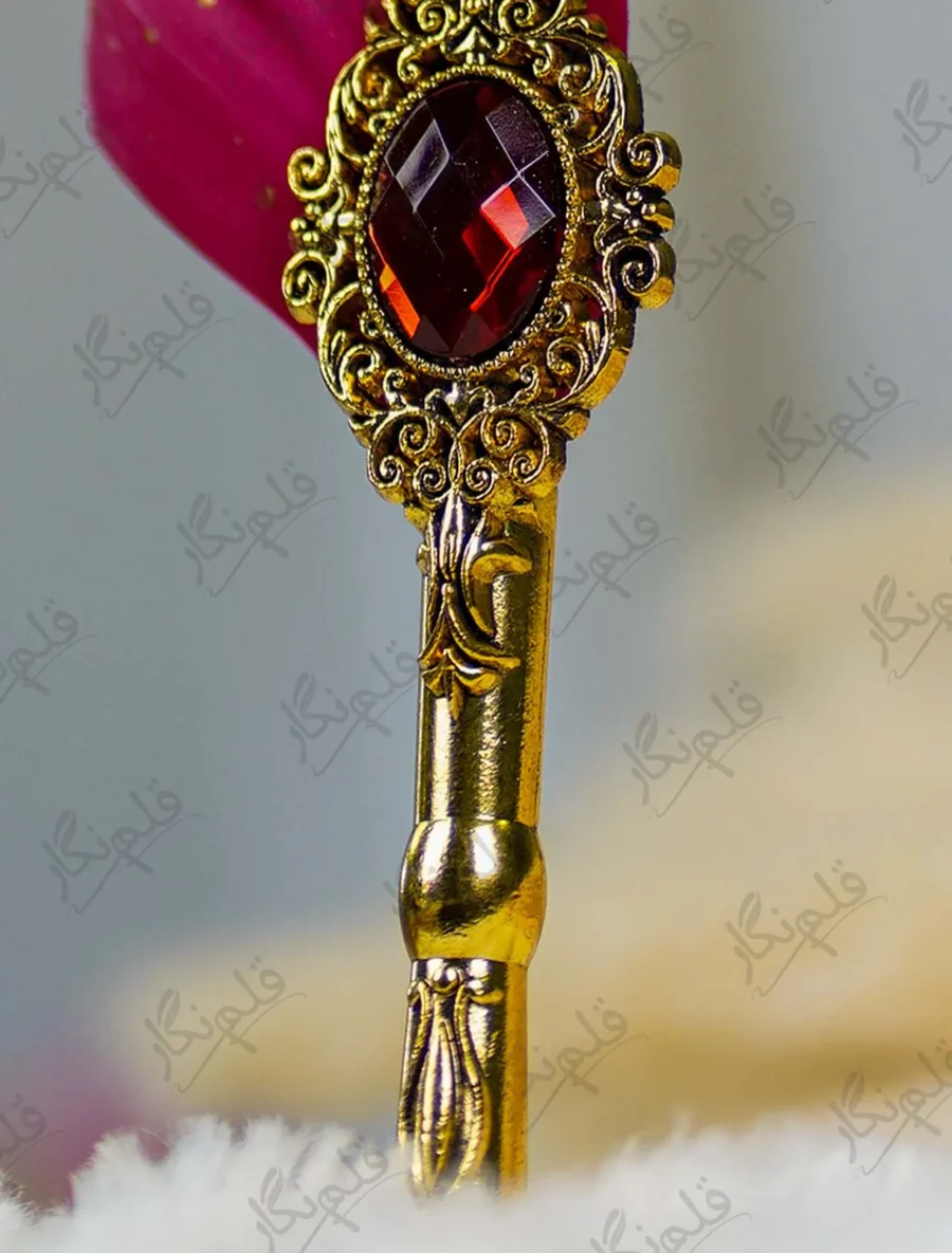 Close up of the red quill feather showing gold paint splatters